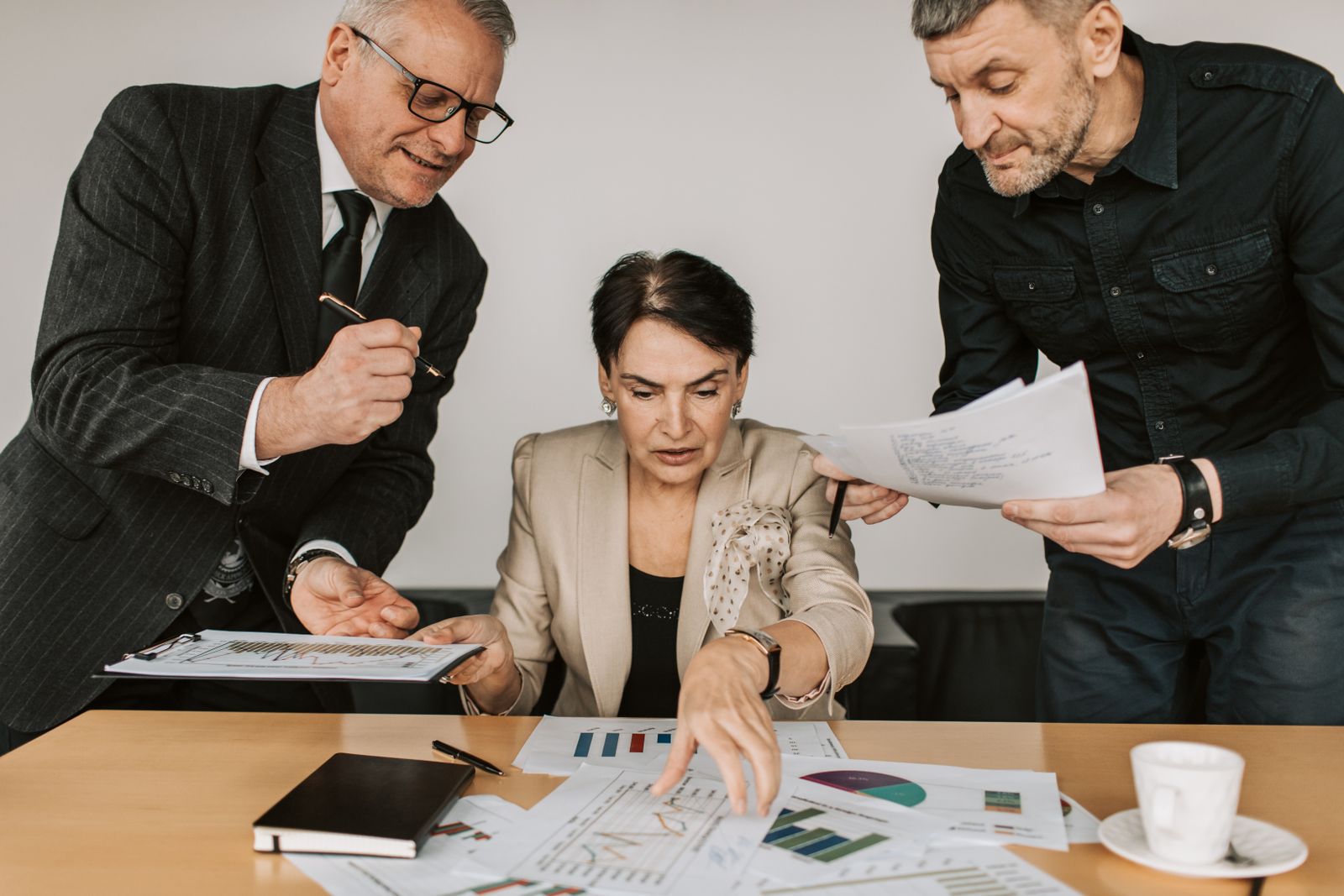 Financial-services professionals reviewing business performance in a modern office.